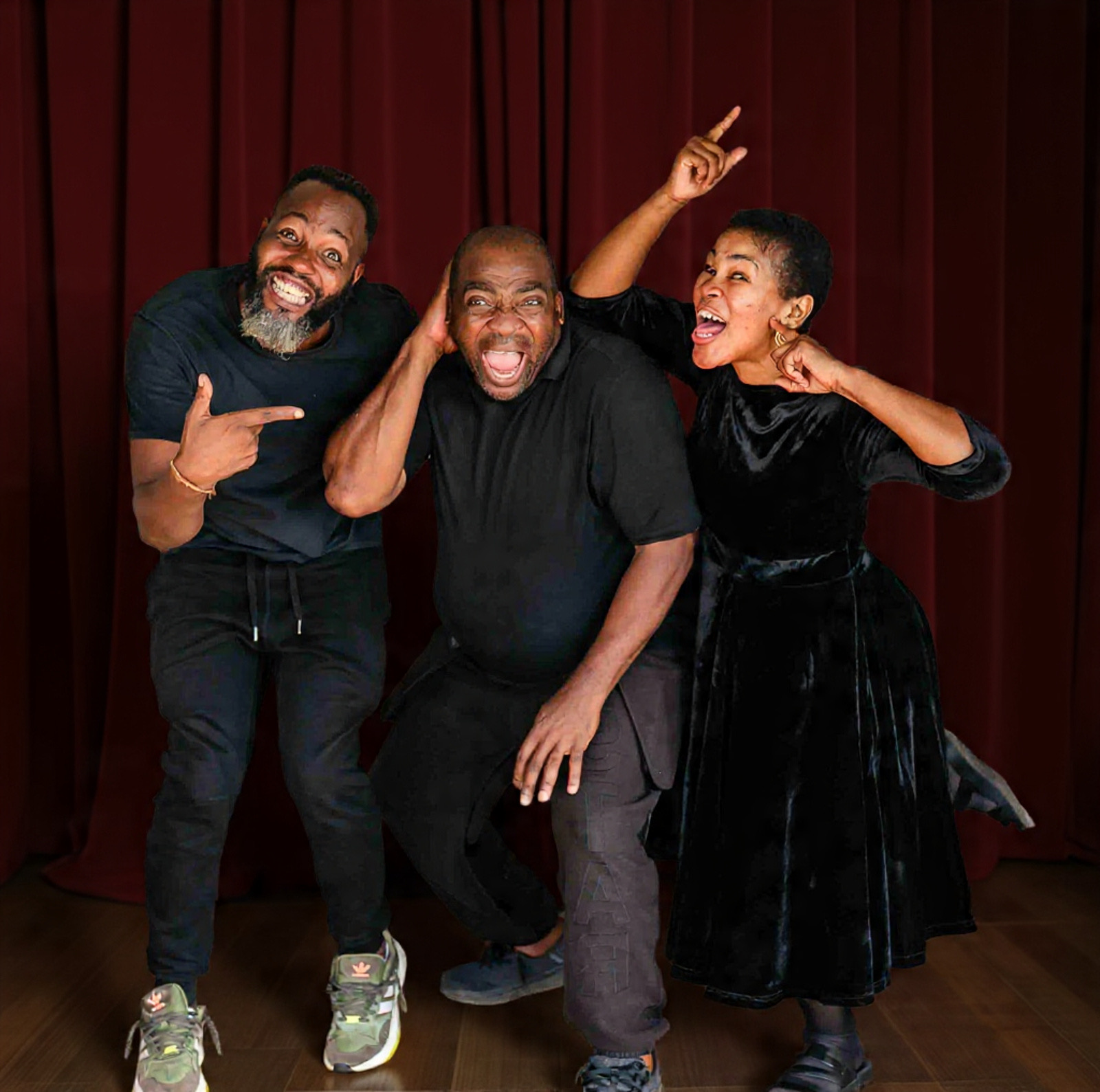 Three Properlymade performers in joyful character poses on stage
