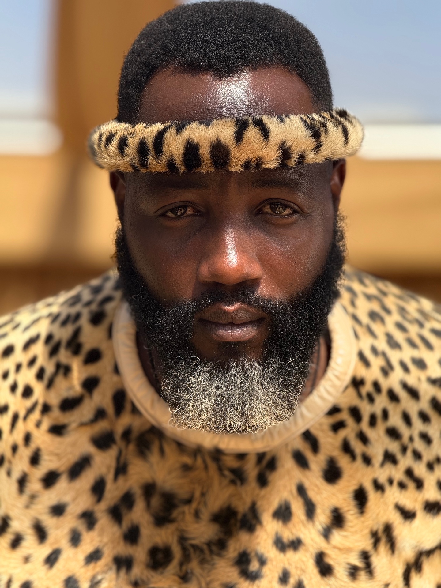Menzi Biyela in traditional Zulu leopard-print regalia, close portrait